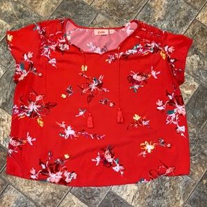 EVRI red floral short sleeve with v-back and tassels. Ruffle detail on shoulder.